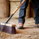 Industrial street broom designed for sweeping heavy debris on extra-rough surfaces.