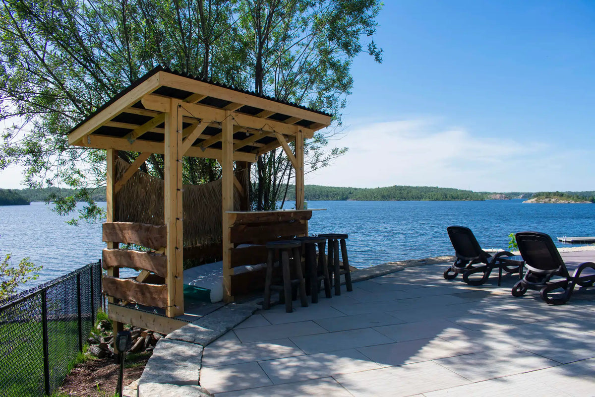 Custom outdoor living space built by Futurescape beside the water