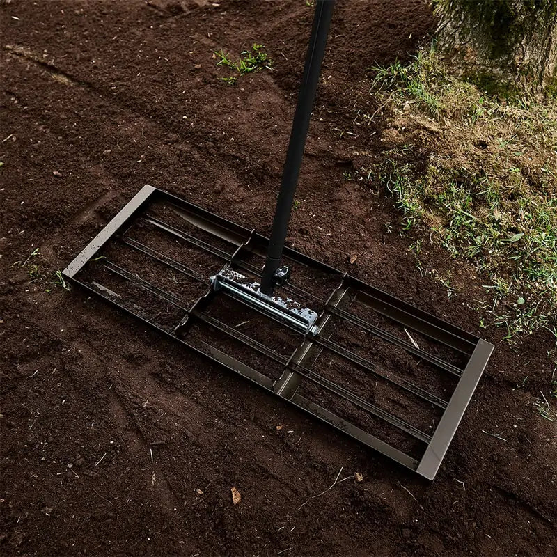 Garant Pro lawn leveling rake with 30-inch steel plate for spreading soil, sand, and compost on uneven yards.