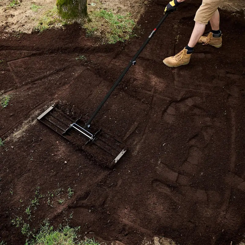 Garant Pro lawn leveling rake with 30-inch steel plate for spreading soil, sand, and compost on uneven yards.